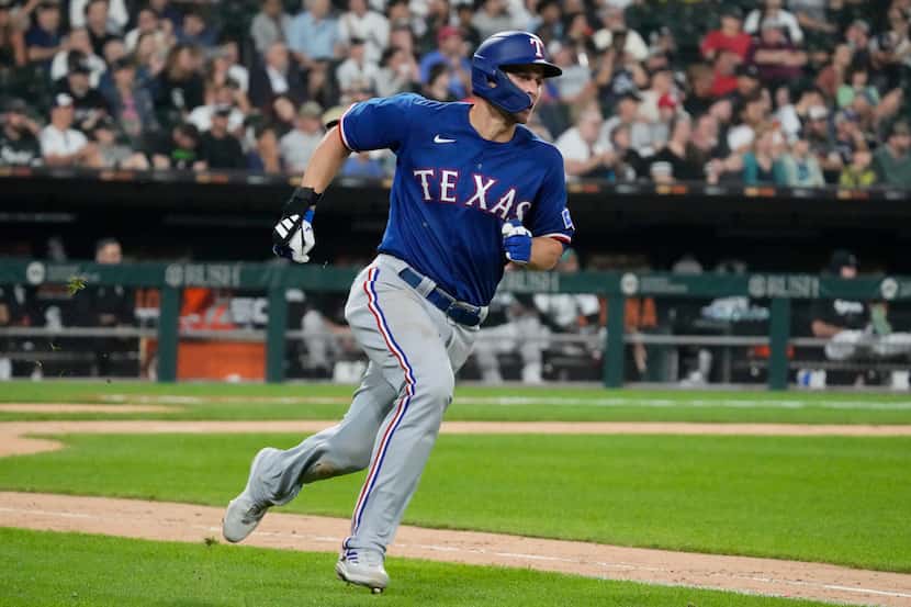 Texas Rangers' Corey Seager runs after hitting a two-run double against the Chicago White...