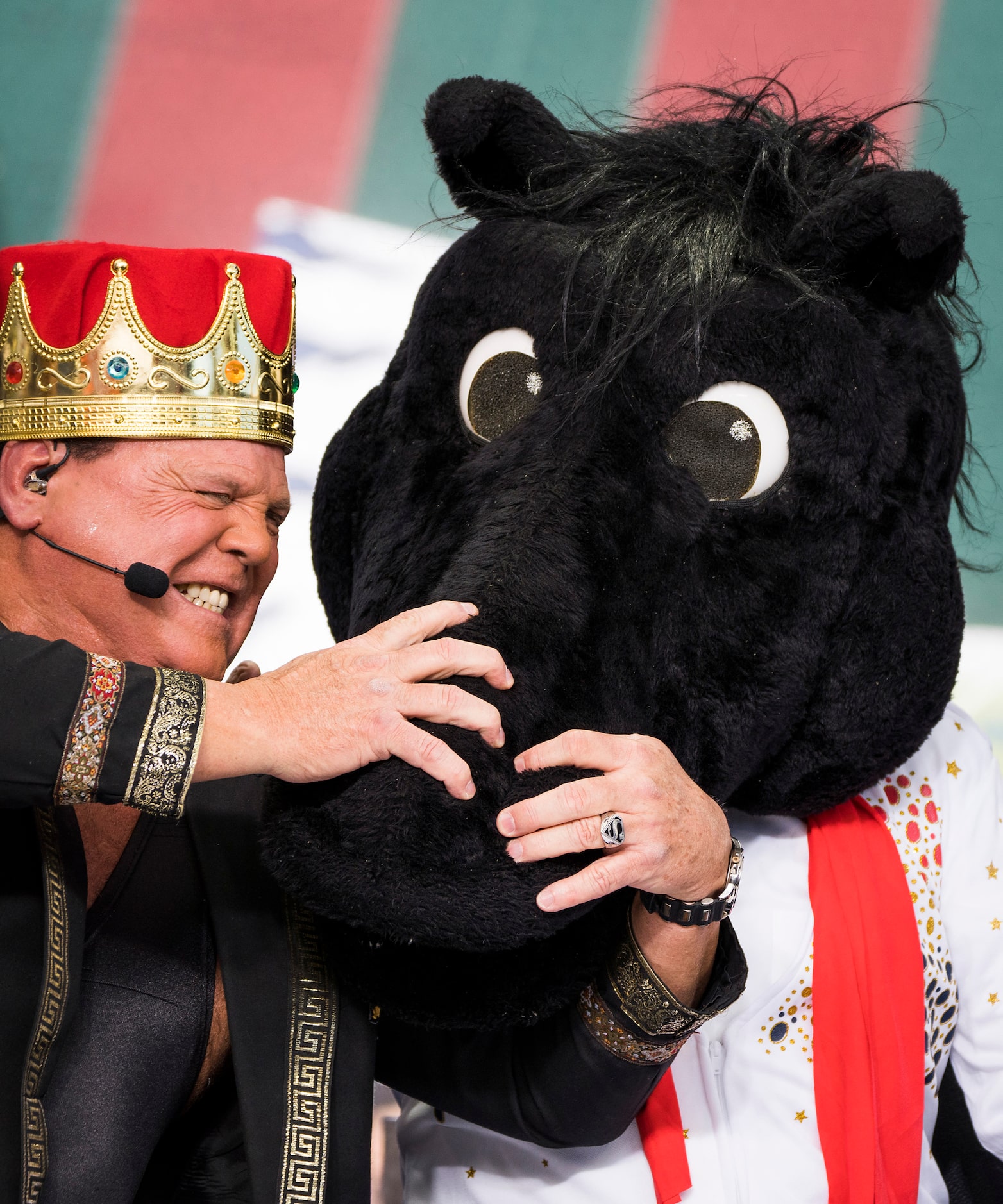 Guest picker Jerry 'The King' Lawler grabs the headgear of SMU mascot Peruna worn by Lee...