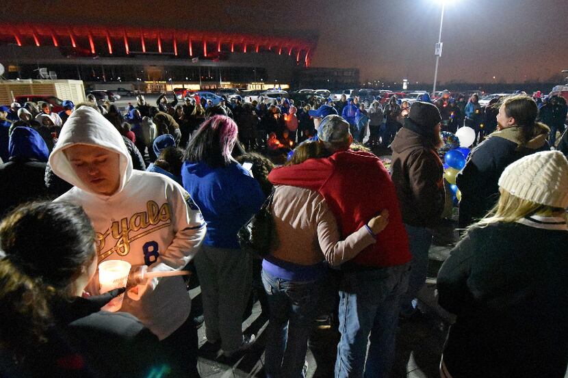 Fans attend a candlelight memorial on Sunday, Jan. 22, 2017 outside Kauffman Stadium in...