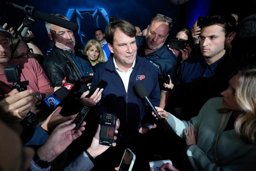 Ford CEO Jim Farley is swarmed by reporters at the North American International Auto Show in...