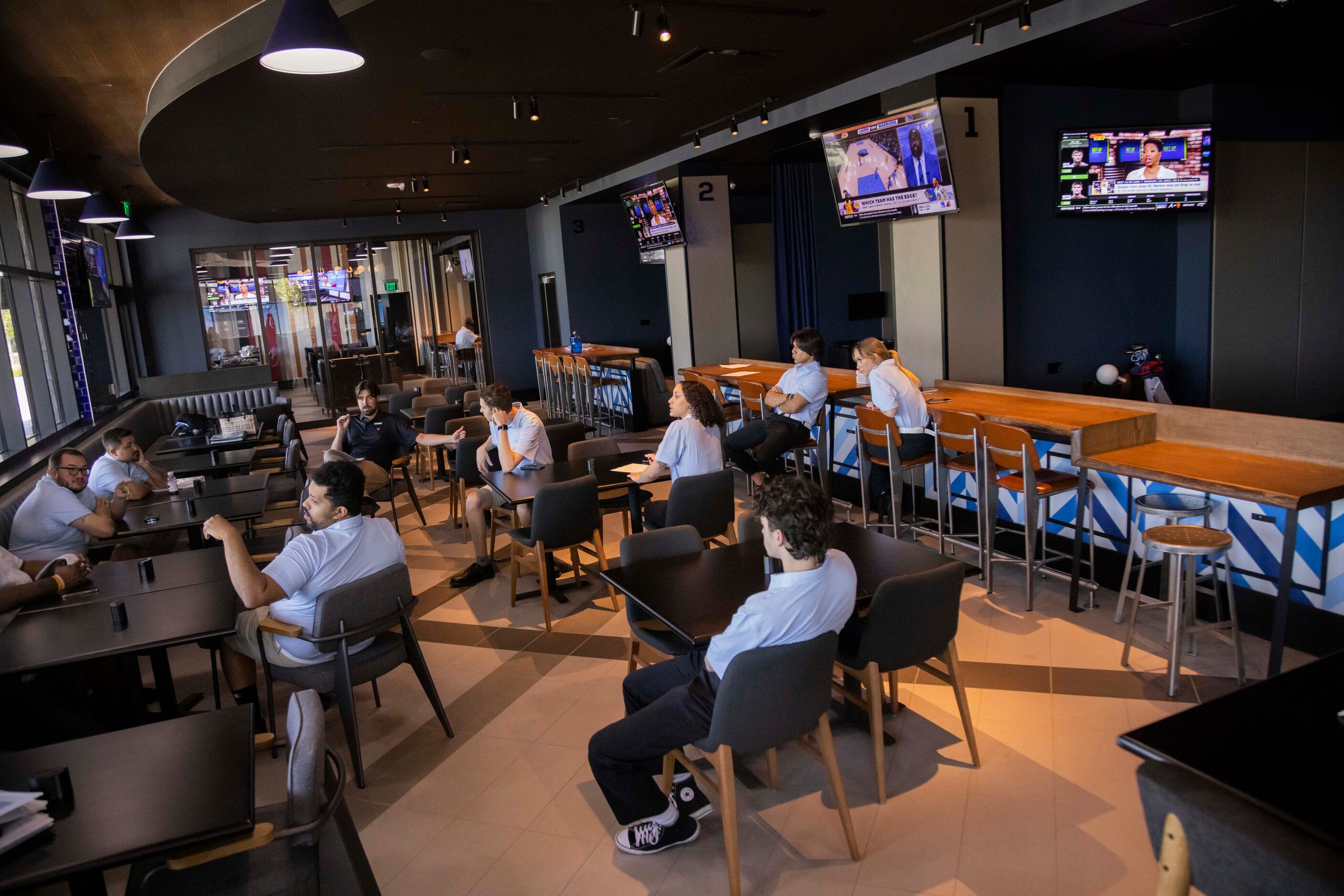 Employees sit through training at the Omni PGA Frisco Resort’s Lounge by Topgolf in Frisco...