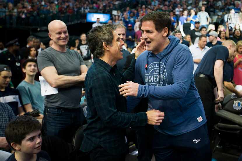 Dallas Mavericks owner Mark Cuban hugs actor Ben Stiller before an NBA basketball game...