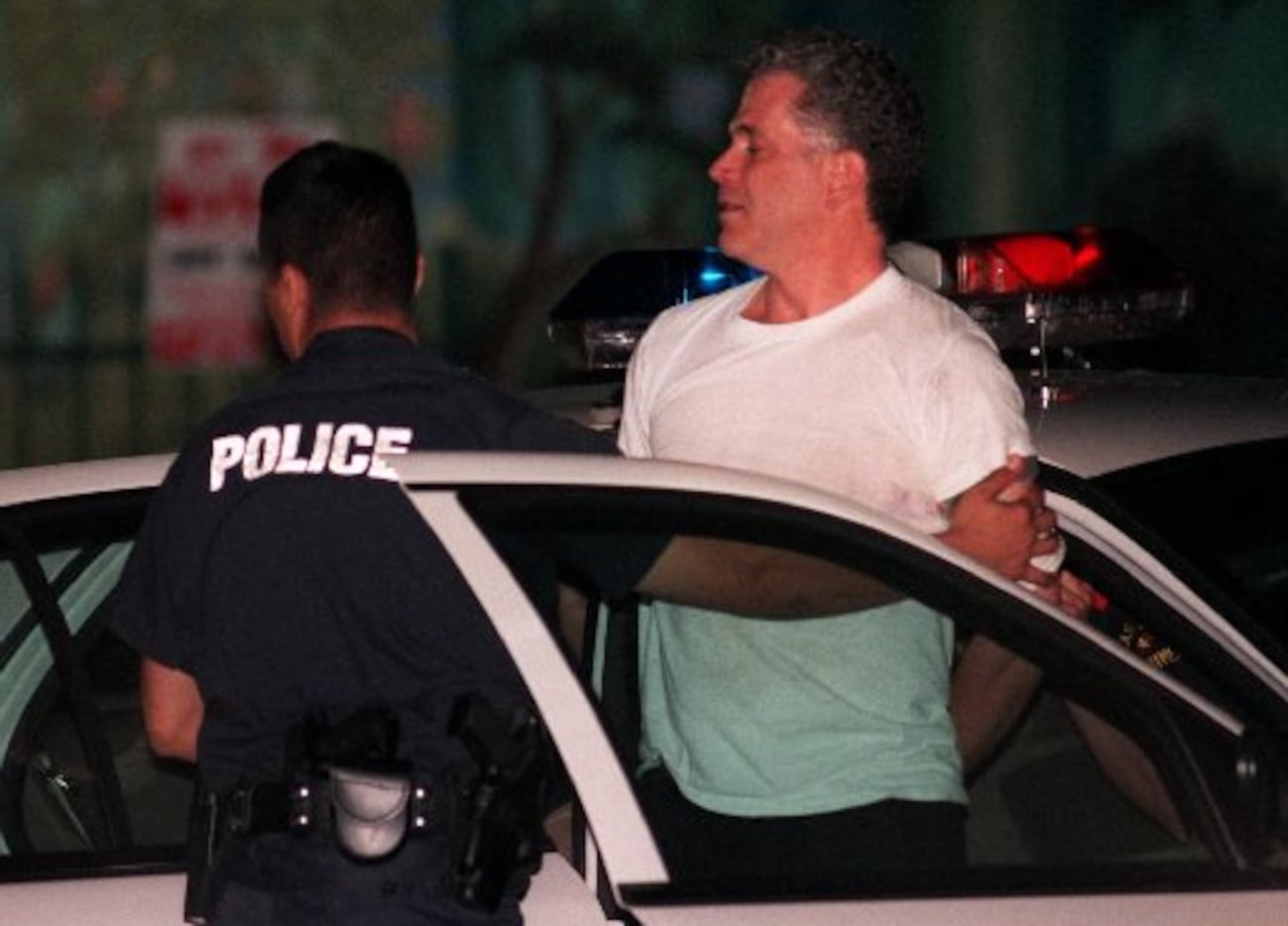 Police take John Battaglia into custody in the shooting deaths of his daughters.