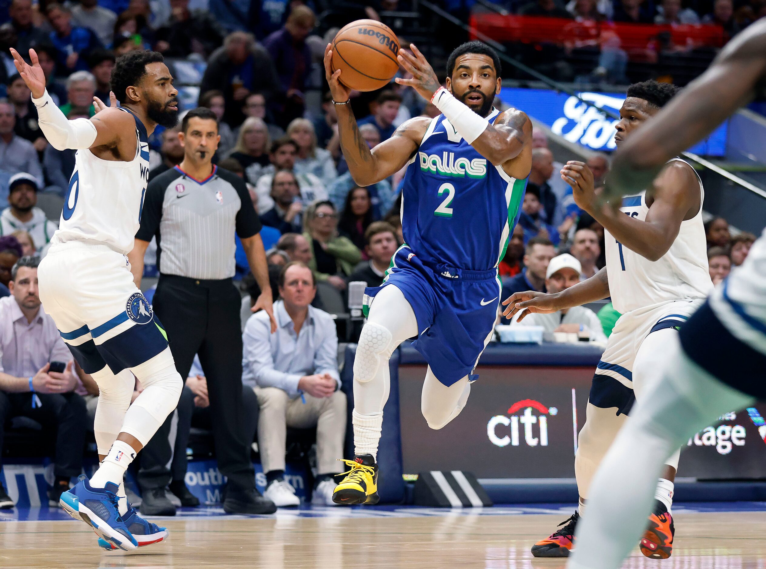 Dallas Mavericks guard Kyrie Irving (2) leaps past Minnesota Timberwolves guard Anthony...