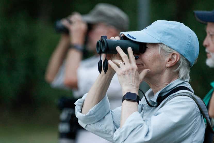 Kris Carlson of Dallas watches for birds with other members of the Prairie and Timbers...