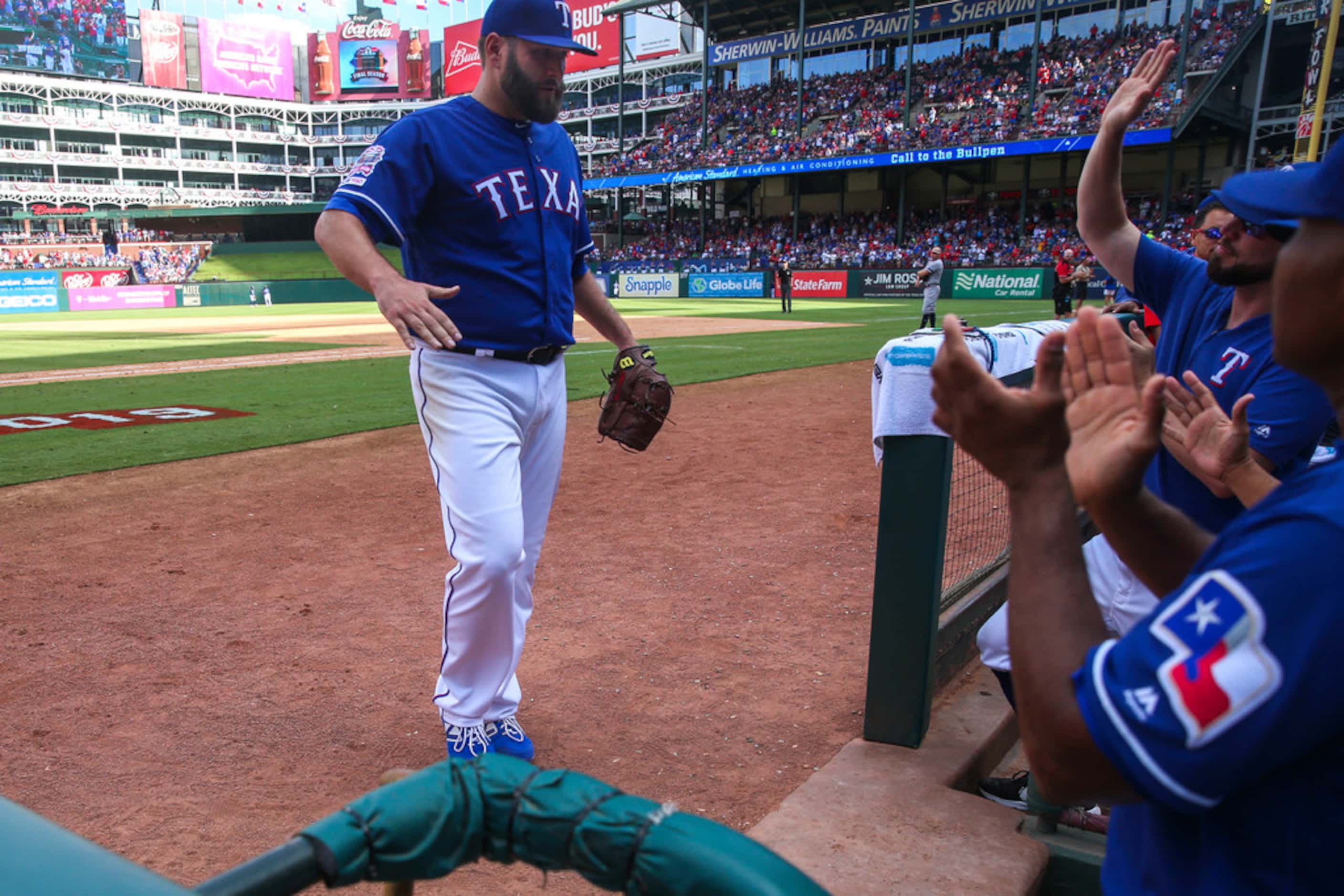Texas Rangers starting pitcher Lance Lynn (35) is congratulated by his teammates after...