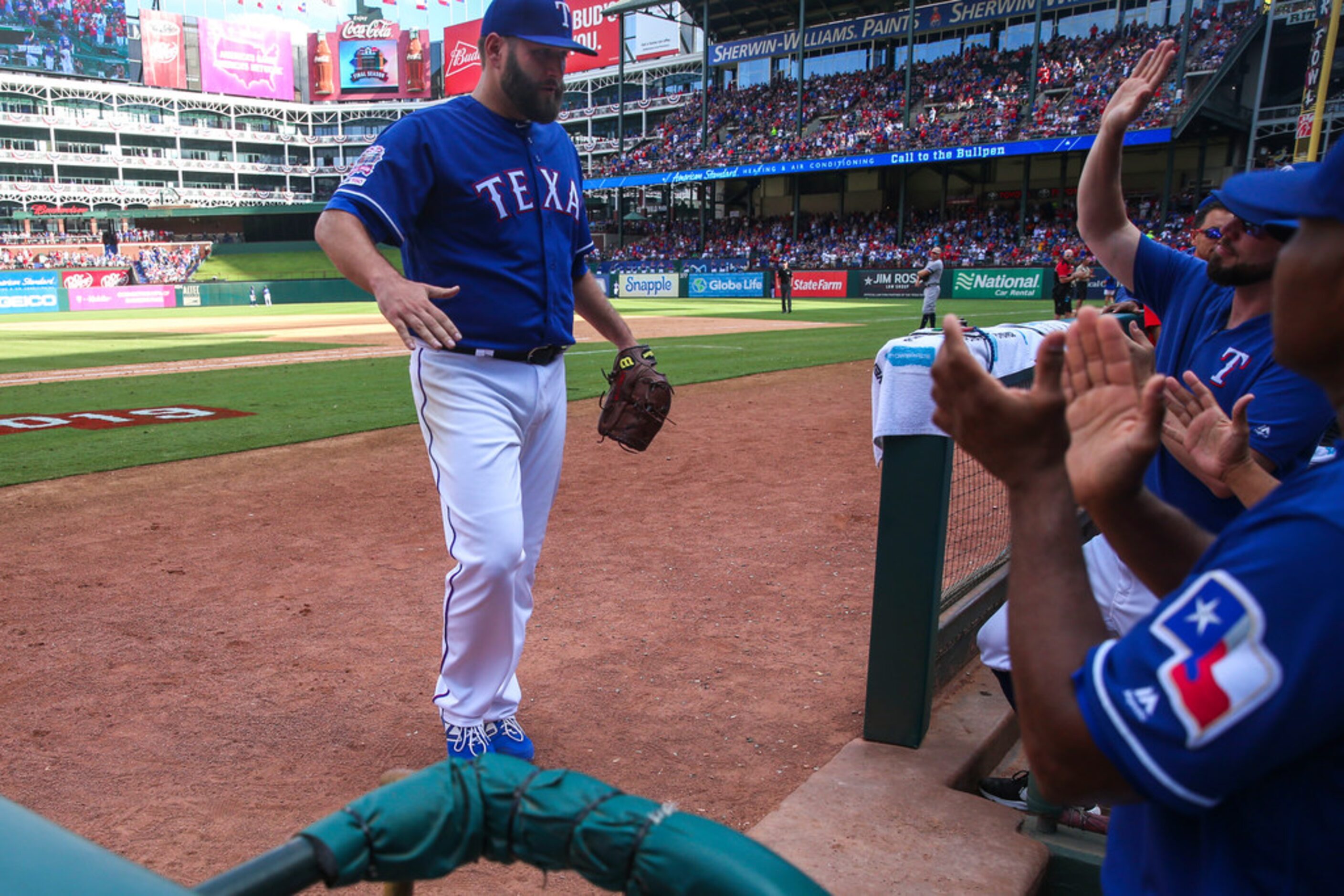 Texas Rangers starting pitcher Lance Lynn (35) is congratulated by his teammates after...