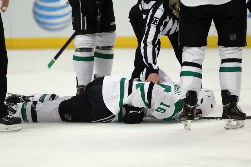 CHICAGO, IL - DECEMBER 03: Ryan Garbutt #16 of the Dallas Stars falls to the ice after being...