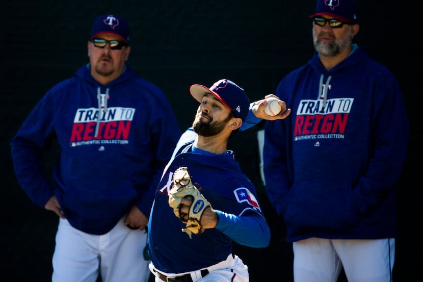 Texas Rangers starting pitcher Nick Martinez (22) pitches in the bullpen while bullpen coach...