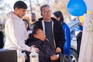 (From left) Angel Lopez, 19, holds his aunt and uncle, Jose Antero and Primitiva Cobos, as...