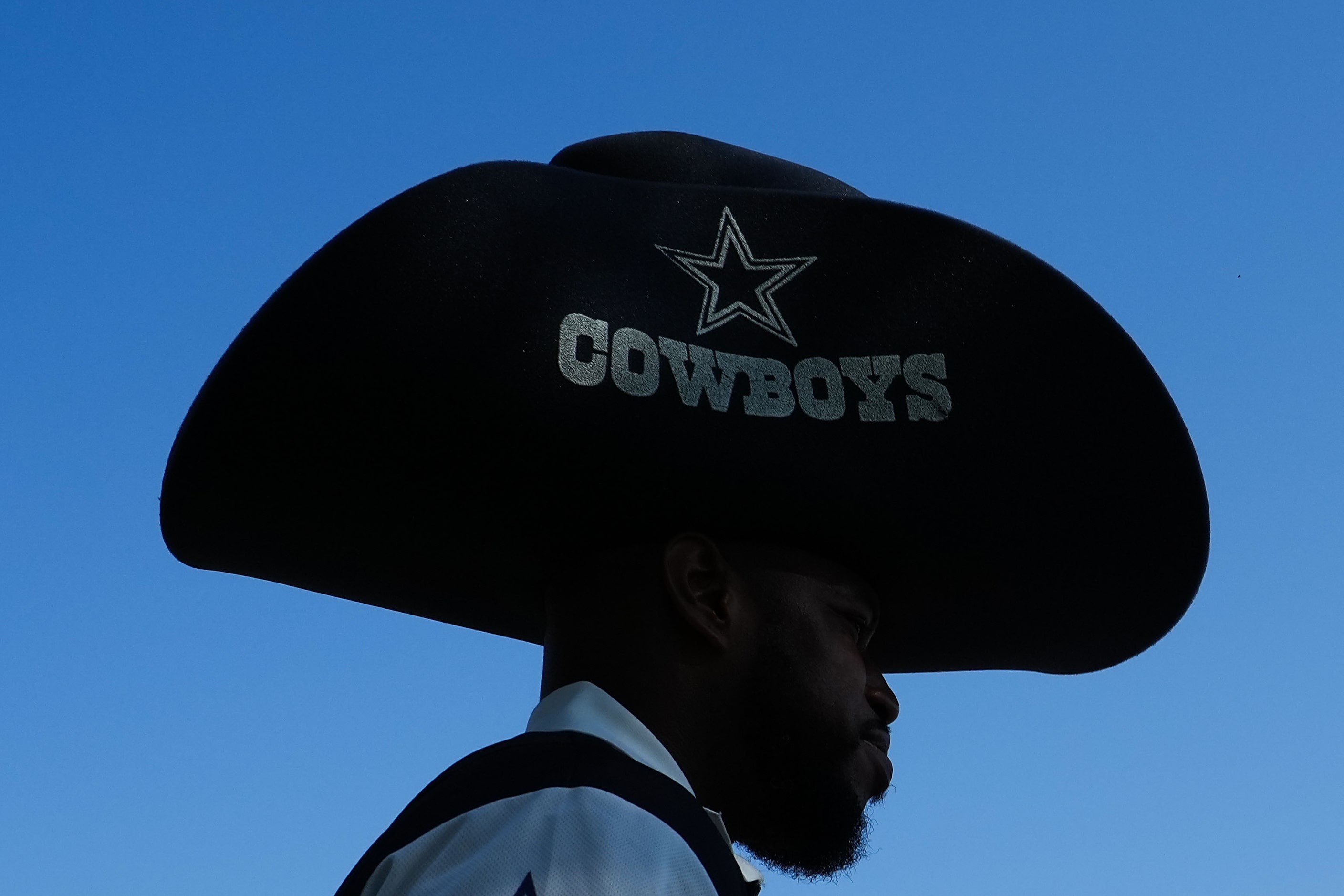 Fans head to the stadium before an NFL football game between the Dallas Cowboys and the New...