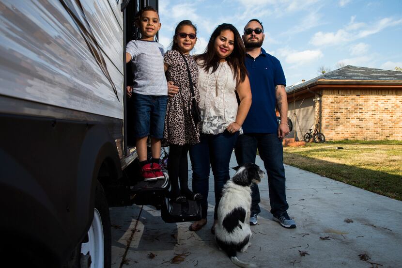 Sebastian Vega, 5, Trinity Vega, 7, Jenny Vega and Alex Vega pose for a portrait outside a...