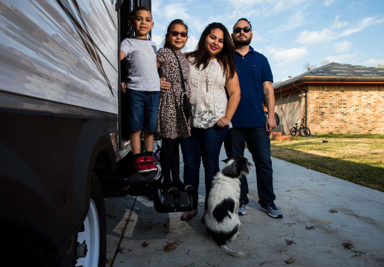 Sebastian Vega, 5, Trinity Vega, 7, Jenny Vega and Alex Vega pose for a portrait outside a...