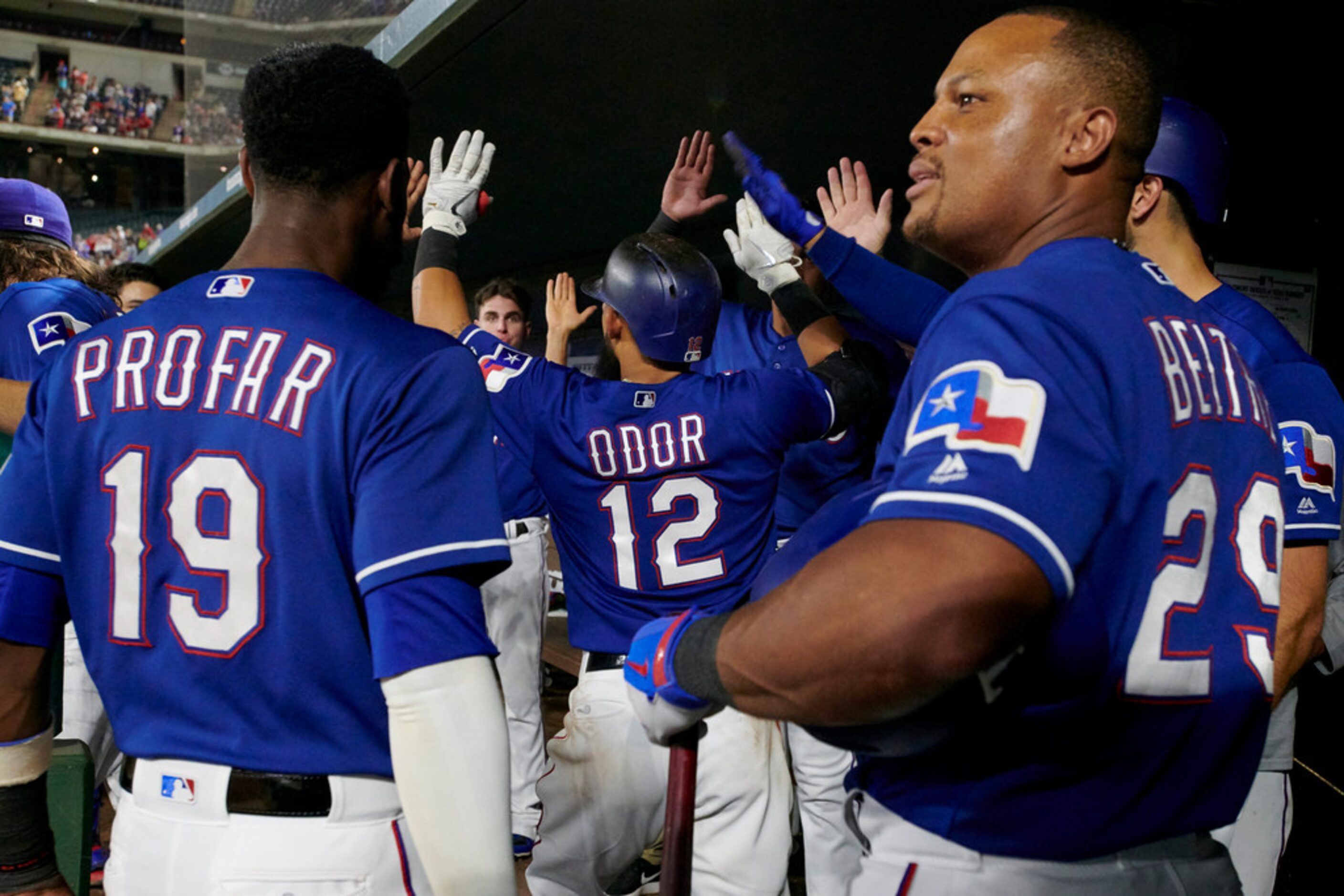 Texas Rangers' Rougned Odor is congratulated after hitting a home run in the eighth inning...