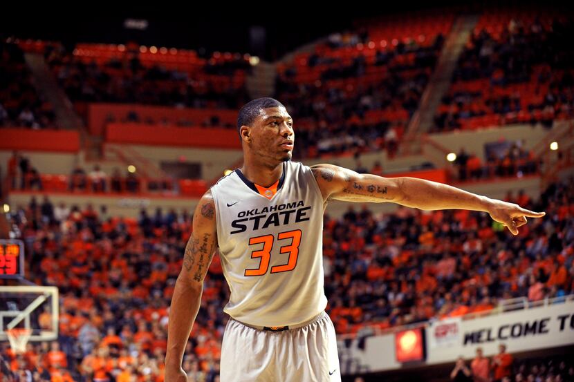 Oklahoma State guard Marcus Smart points during an NCAA college basketball game in...
