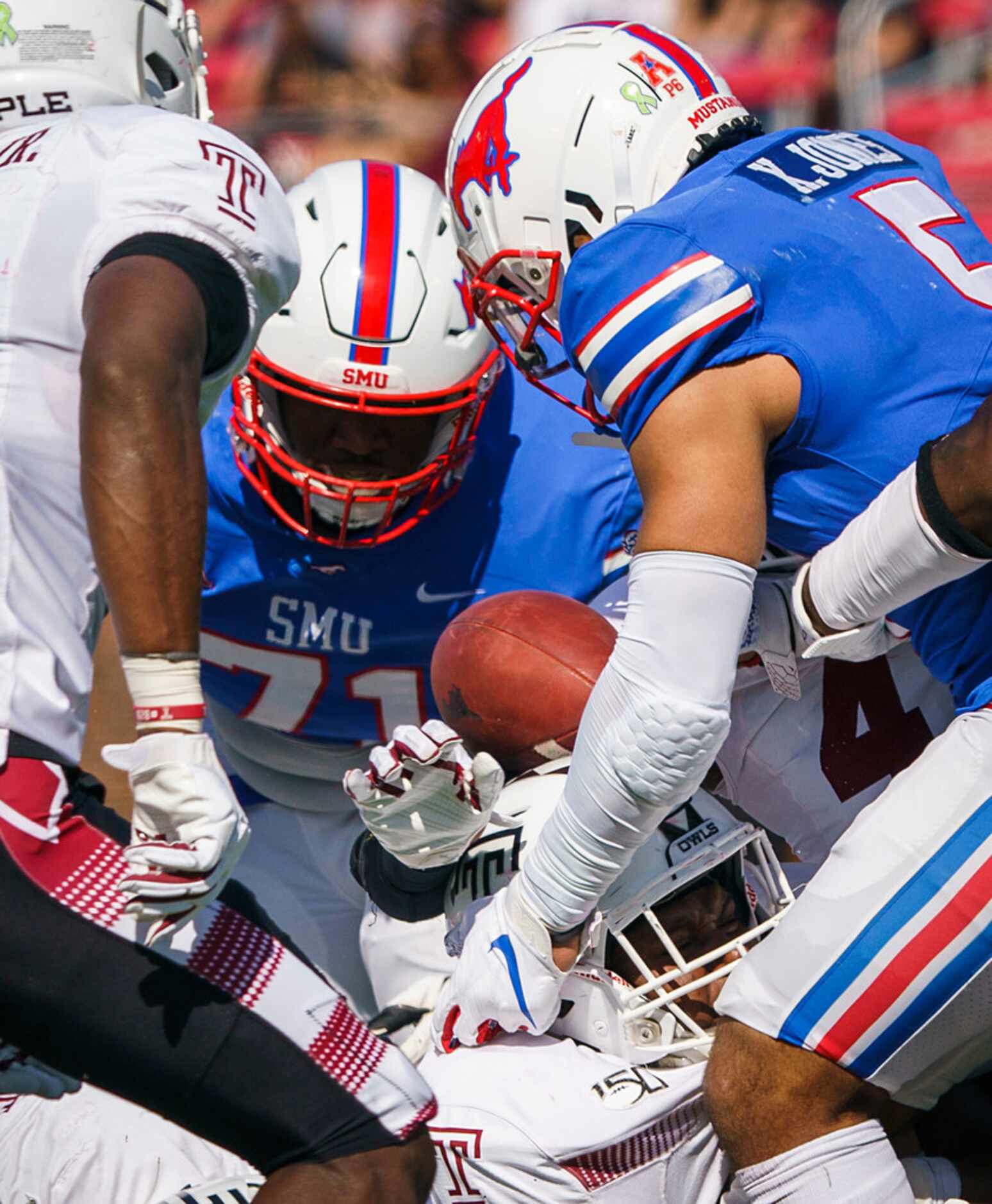 SMU running back Xavier Jones (5) grabs his own fumble from a pileup during the first half...