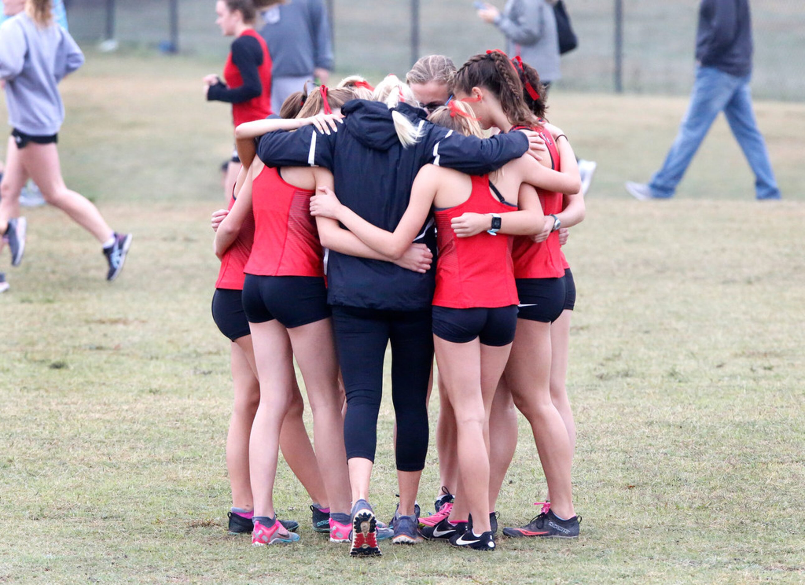 The Lovejoy High School cross country team huddles before the start of their race at the...