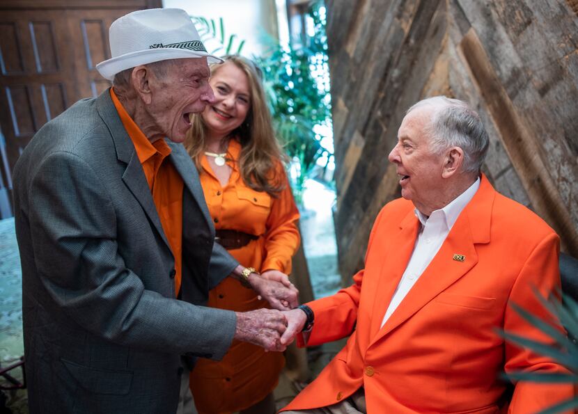 Jim Moeller (left) greeted Pickens at his 90th birthday party at the Dallas Country Club on...