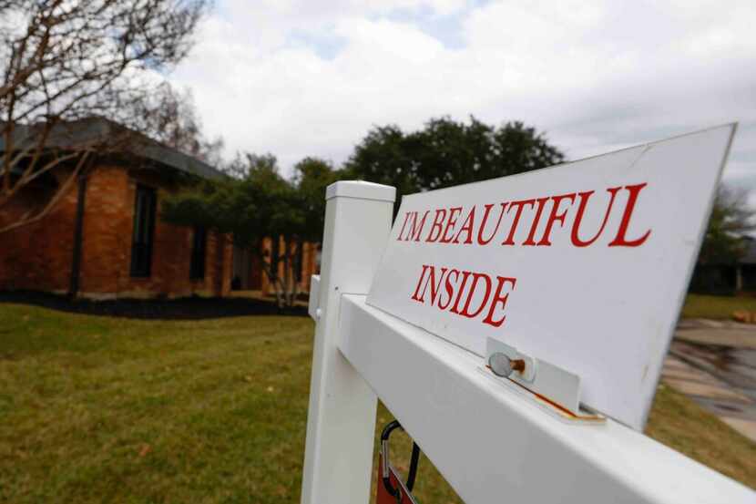 A “for sale” sign is displayed outside of a house in Carrollton on Tuesday, Dec. 13, 2022....