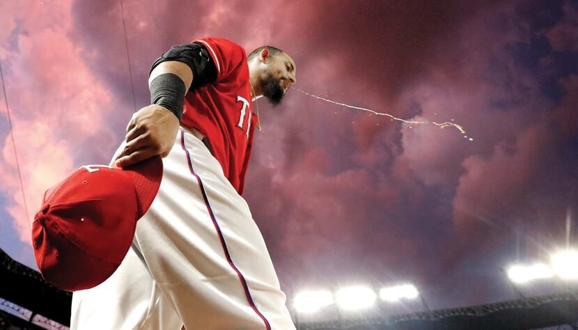 Texas Rangers second baseman Rougned Odor headed out to the field under stormy skies in the...