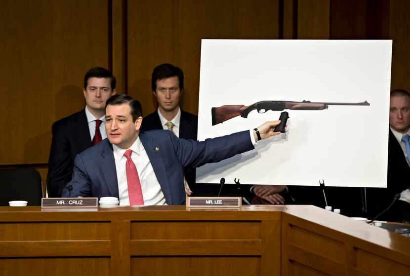 Freshman Sen. Ted Cruz, R-Texas uses a life size photo of a Remington 750, a popular hunting...