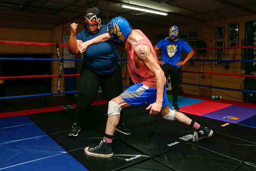 Dylan Cantu as Huitzi, center, throws a strike towards Tiffany Lang as Coyol as wrestling...