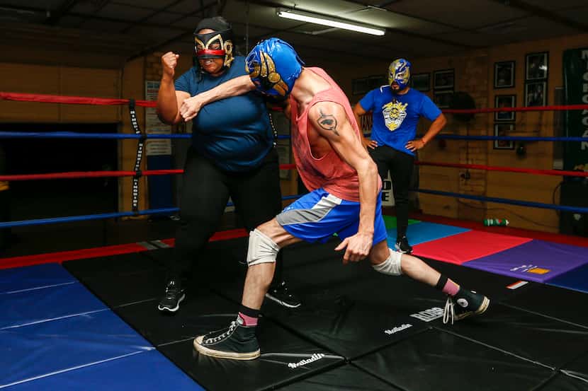 Dylan Cantu as Huitzi, center, throws a strike towards Tiffany Lang as Coyol as wrestling...