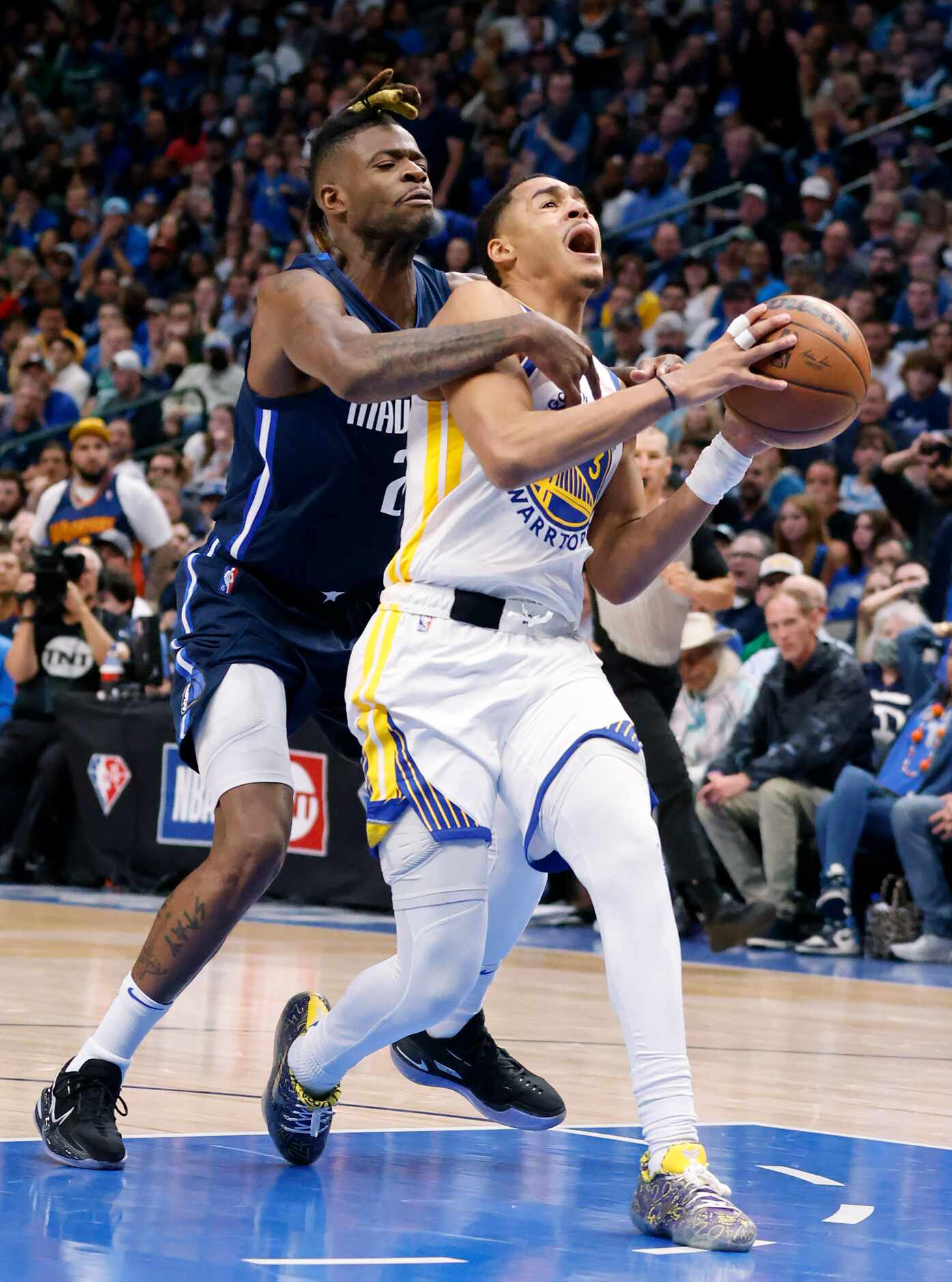 Dallas Mavericks forward Reggie Bullock (25) tackles Golden State Warriors guard Jordan...