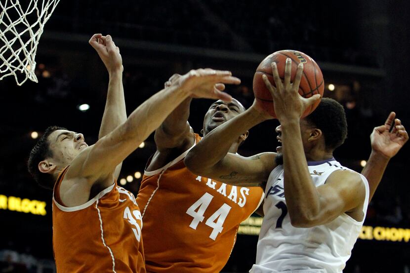 Texas forward Ioannis Papapetrou (33) and center Prince Ibeh (44) defend against Kansas...