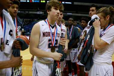 Justin Northwest's Christian Healer (22), center, exits the court with his team after...