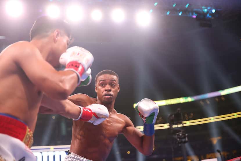 Errol Spence Jr., right, fights Mikey Garcia, left, during a IBF World Welterweight...