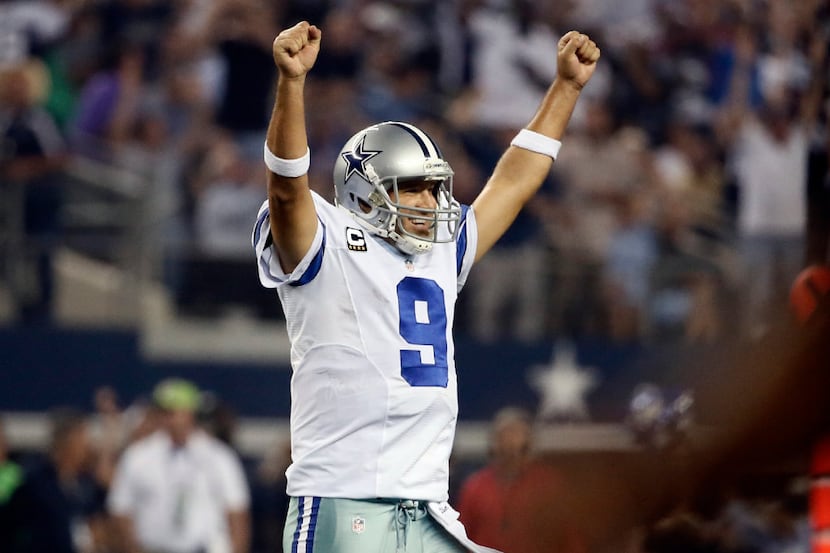 Tony Romo celebrates a touchdown run by DeMarco Murray during the second half of an NFL...