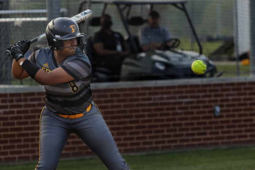 Vanessa Hollingsworth prepares to swing for the ball during a softball game between Forney...