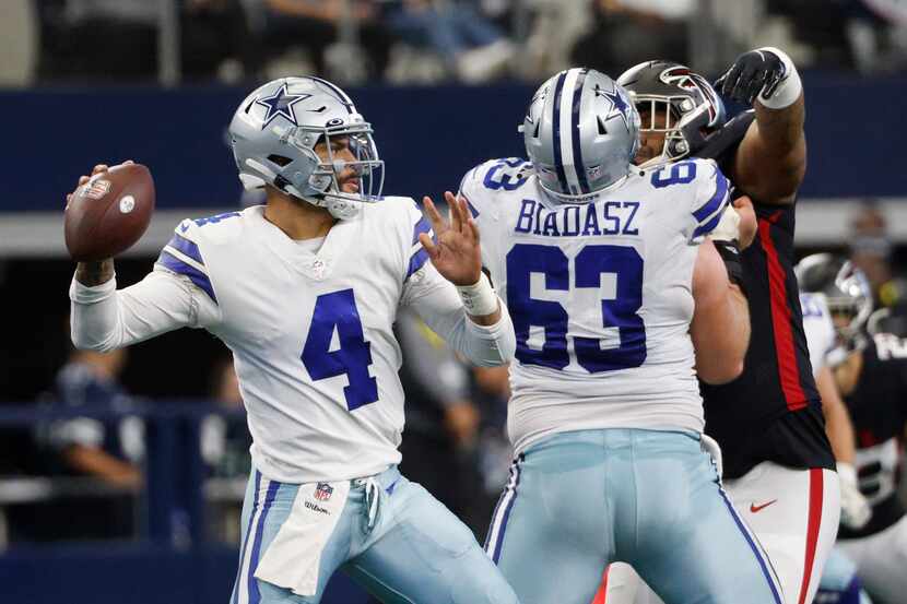 Dallas Cowboys center Tyler Biadasz (63) blocks as quarterback Dak Prescott (4) throws a...