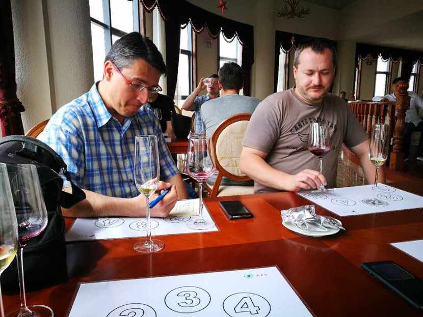 Tourists from the Czech Republic compare Chinese wines on their wine tour from Easy Tour China.
