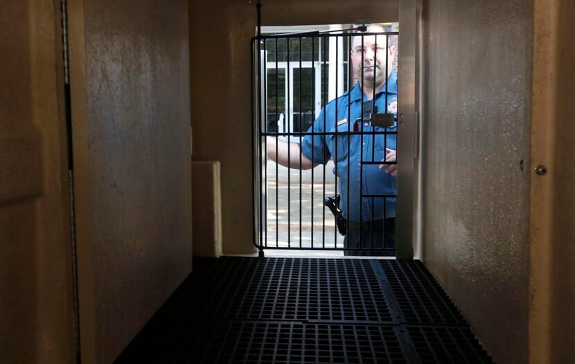 
Addison Animal Control Officer Kevin Kimbrell shows a holding area on the new animal...