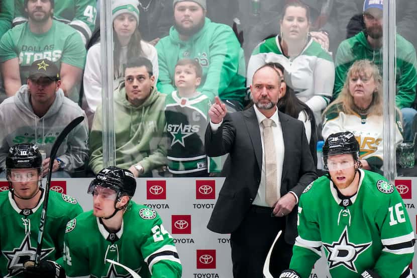 Dallas Stars head coach Pete DeBoer motions from the bench during the third period of an NHL...