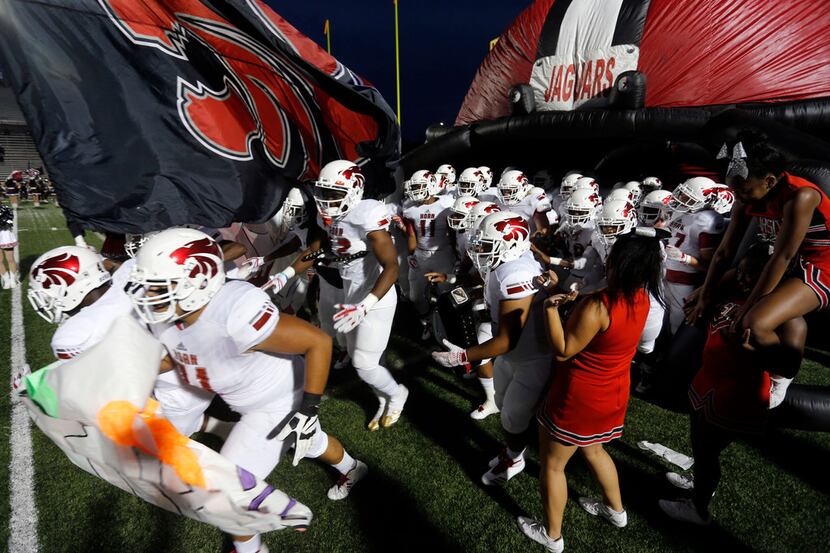 The Mesquite Horn Jaguars take the field before the start of a high school football game...