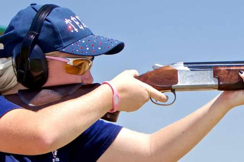 
 Freshman Olivia Mehmken, 14, takes aim at a clay disc during a skeet-shooting practice at...