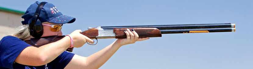 
 Freshman Olivia Mehmken, 14, takes aim at a clay disc during a skeet-shooting practice at...
