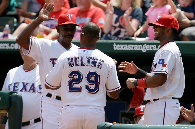 Texas Rangers' Ron Washington, left, and Elvis Andrus, right, congratulate Adrian Beltre...
