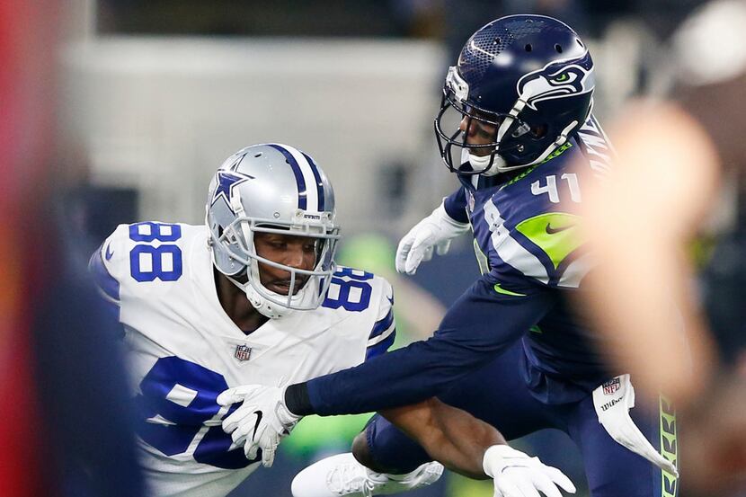 Dallas Cowboys wide receiver Dez Bryant (88) fumbles the ball as he is defended by Seattle...