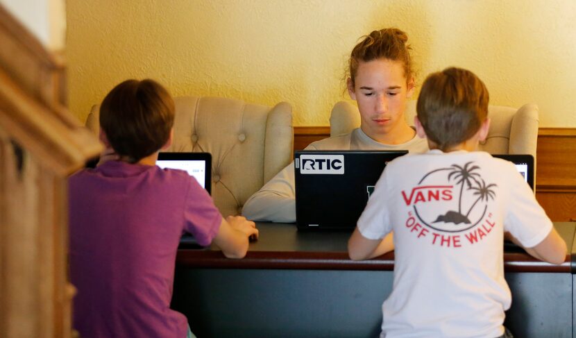 The Yearout brothers -- (from l to r) Aden, 14 ; Asher, 15; and Ashton, 11 -- work on...