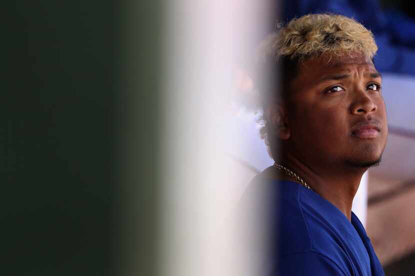 SURPRISE, AZ - MARCH 05:  Willie Calhoun #5 of the Texas Rangers watches from the dugout...