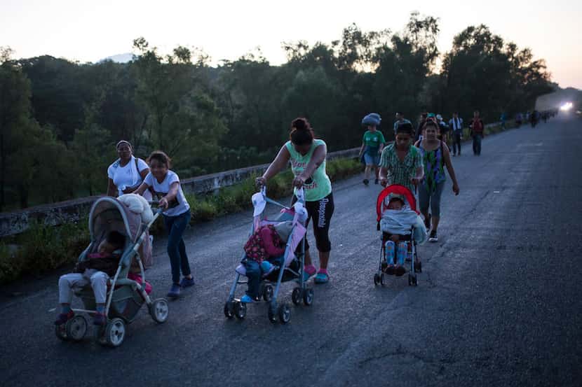 Central American migrants traveling with a caravan to the U.S. make their way to Pijijiapan,...