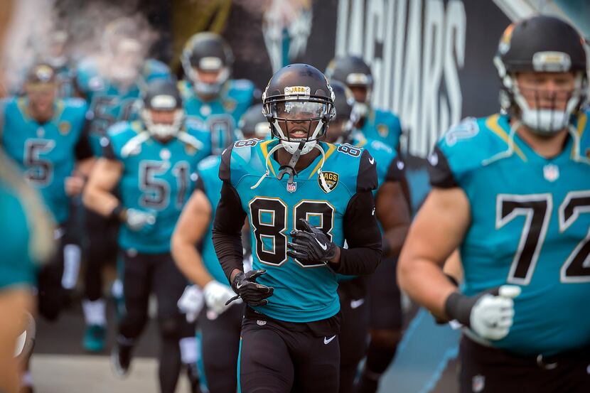 FILE - Wide receiver Allen Hurns (88) runs onto the field before the start of a game between...