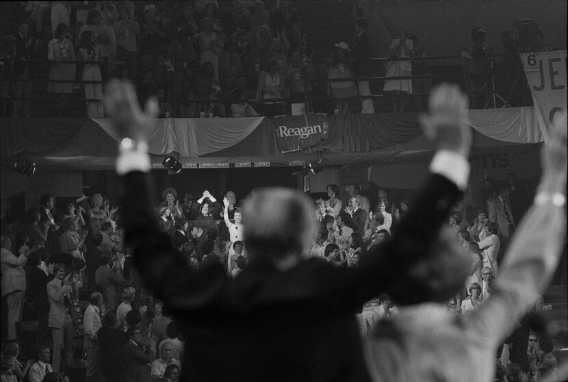 
Ronald and Nancy Reagan wave back from the crowd to Gerald and Betty Ford on stage during...