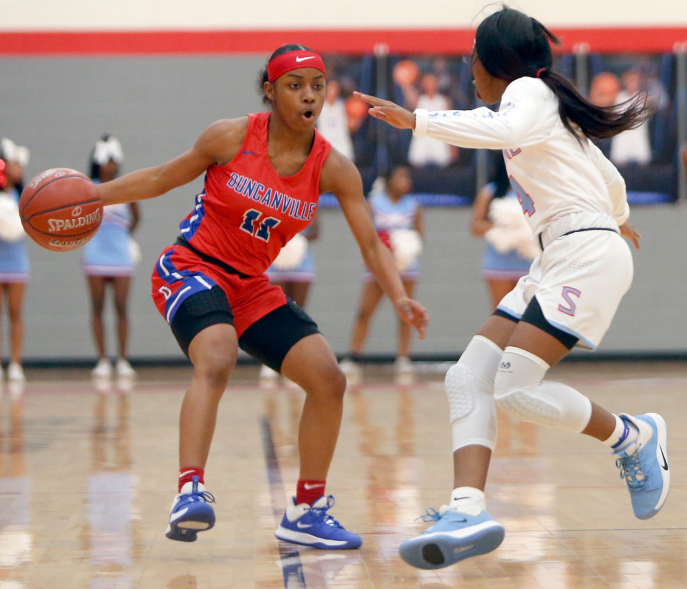 Duncanville's Tristen Taylor (11) drives against the defense of Dallas Skyline's Kennedi...