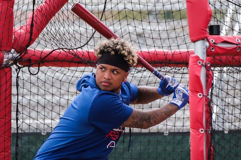Texas Rangers outfielder Willie Calhoun takes batting practice following the first pitchers...