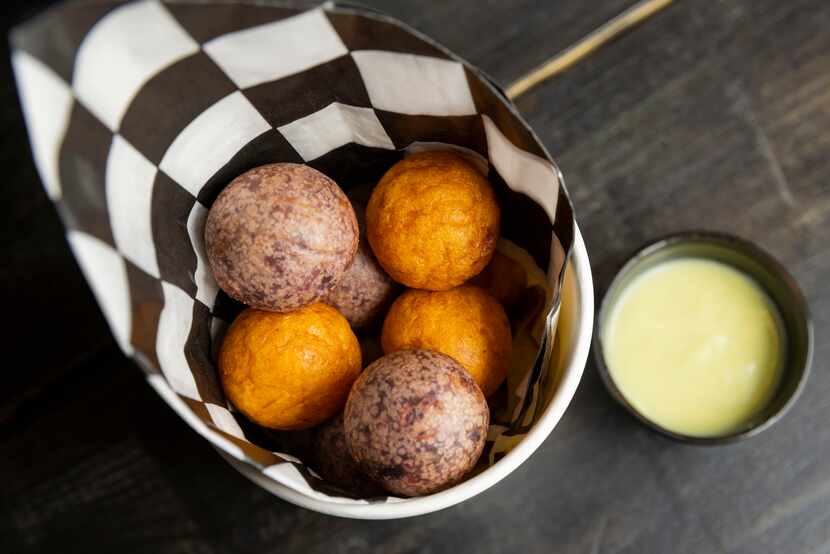 The Darkoos eggs, which are chewy, fried balls of sweet potato and purple yams, are served...